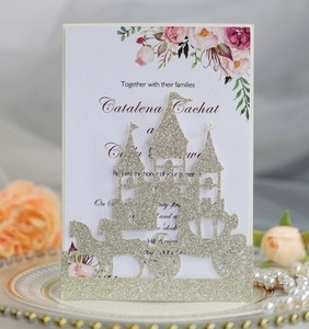 Detailed laser-cut silver glitter castle wedding invitation on decorative dinner plate
