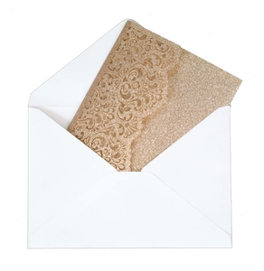 Detail of laser-cut glitter greeting card in gold with an elegant white envelope