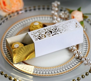 Detailed laser-cut white wedding favor box with gold insert and rose hollow pattern