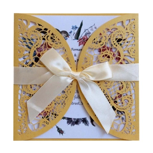 Bright yellow laser-cut butterfly wedding invitation card with a cream silk ribbon bow