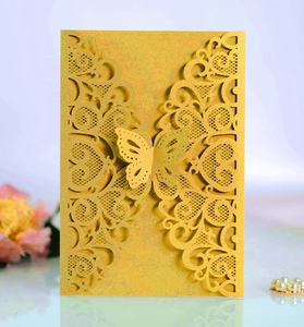 Detailed laser-cut gold wedding invitation cover with a 3D butterfly and floral lace pattern