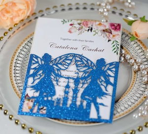 Detail of blue glitter laser-cut castle invitation with floral insert on a deco plate