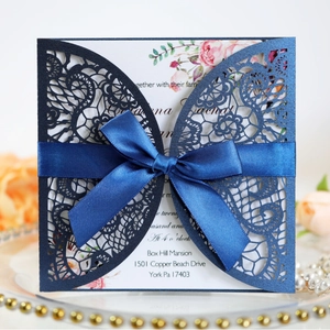 Elegant navy blue laser cut wedding invitation with floral insert and silk bow