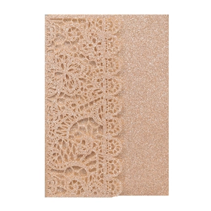 Macro detail of laser-cut floral pattern on rose gold glitter wedding invitation cover
