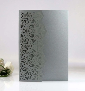 Detail of laser-cut lace pattern on elegant silver-grey pearlescent paper invitation card