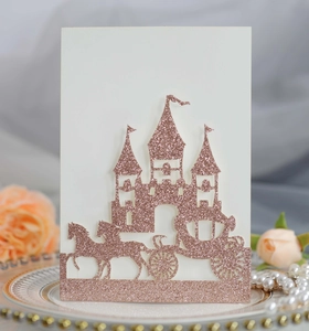 Detail of laser-cut glitter rose gold castle and carriage wedding invitation card