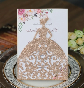 Detail of rose gold glitter laser cut dress cover and floral wedding invitation card