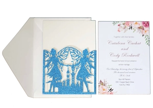 Detail of blue glitter laser-cut wedding invitation featuring a fairy and castle motif
