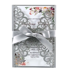 European laser-cut lace wedding invitation in silver with grey ribbon and floral card