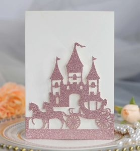 Detail of pink glitter laser-cut wedding invitation with castle and carriage design