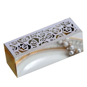 Detail of laser-cut rose hollow candy box in metallic silver and gold finish
