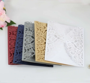 Detailed laser-cut lace patterns on multi-colored luxury cardstock wedding invitations