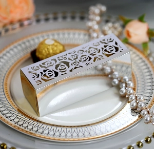 Macro shot of silver laser-cut rose hollow gift box on a luxury ceramic plate