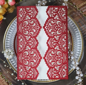 Detail showing red glitter laser-cut floral wedding invitation card with ivory insert