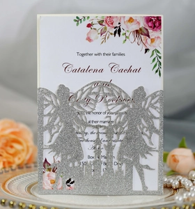 Close-up of glitter silver laser-cut fairy castle invitation with floral inner card
