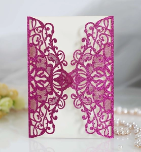 Detailed laser-cut floral pattern on purple glitter paper for elegant wedding invitations