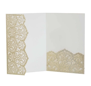 Macro view of laser-cut glitter paper wedding invitation with intricate floral hollow pattern