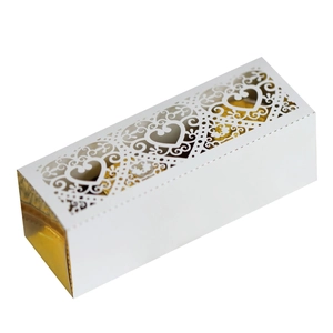 Detailed laser-cut heart pattern on rectangular white gift box with gold metallic lining