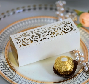 Detailed laser-cut white rose gift box with golden lining for wedding candy or chocolates
