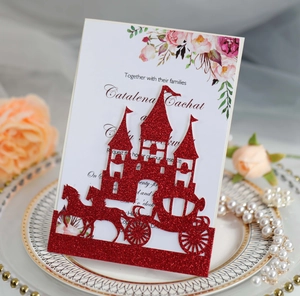 Close-up of red glitter castle laser-cut wedding invitation with floral inner card