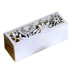 Detailed laser-cut flower and butterfly motifs on a white and gold wedding candy gift box