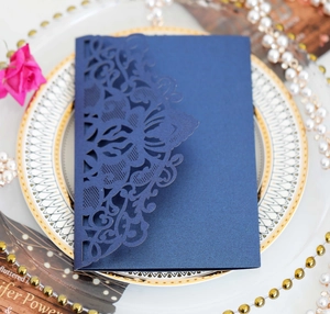 Detail view of navy blue laser-cut wedding invitation card with elegant pearl finish texture