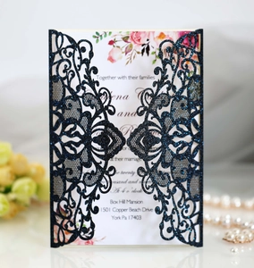 Detail of navy blue glitter laser-cut wedding invitation with elegant floral inner card