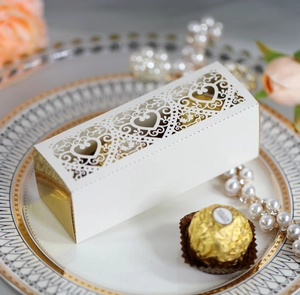 Detailed laser-cut heart pattern gift box with elegant gold lining and white paper exterior