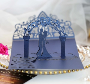 Detail of 3D laser-cut wedding card featuring a romantic couple silhouette and blue arch