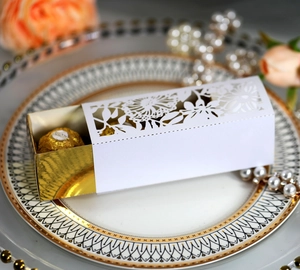 Macro shot of laser-cut hollow rose gift box with gold mirror lining for chocolates