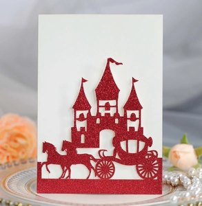 Detail of red glitter laser cut castle and carriage on a white laser cut invitation card