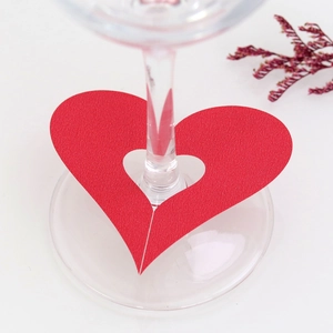 Detail of laser-cut red heart wine glass card for wedding table decoration