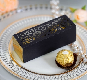 Detailed laser-cut rose hollow gift box in matte black with a golden interior for weddings
