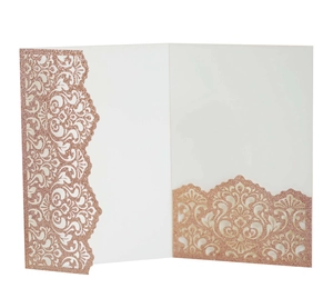 Macro detail of rose gold glitter laser cut wedding invitation with ivory insert card