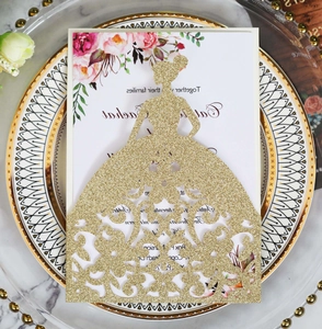 Detail of laser-cut gold glitter wedding invitation with elegant female silhouette