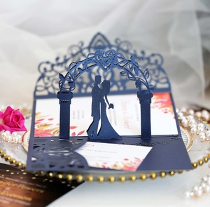 Detail of 3D laser-cut wedding invitation featuring a couple silhouette under a heart arch