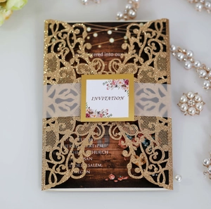 Detail of glitter laser-cut invitation with floral vellum belly band and elegant wood grain card