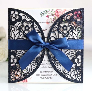 Navy blue glitter laser-cut wedding invitation with elegant floral lace and satin ribbon