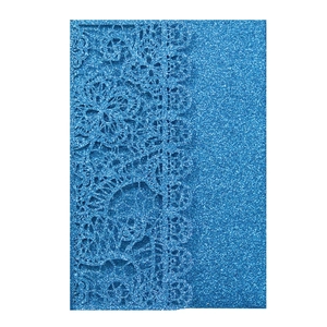 Close-up of laser-cut royal blue glitter invitation card with floral hollowed pattern
