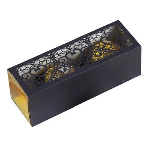 Detailed laser-cut heart pattern on a black gift box showing gold foil candy wrappers
