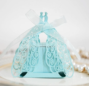 Close-up of laser-cut peacock wedding favor box in light blue with white ribbon bow