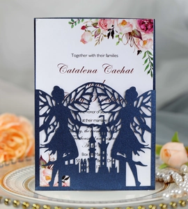 Detail of laser-cut castle and angel design on a navy blue wedding invitation