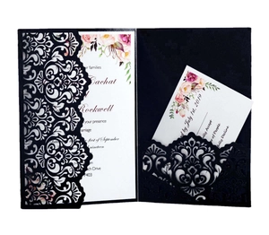Elegant black laser-cut wedding invitation set with floral patterns and white card insert
