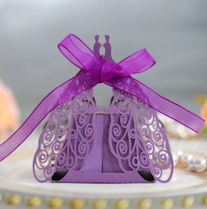 Detail of laser cut purple peacock favor box with shimmering finish and organza ribbon