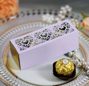 Macro detail of lavender laser-cut heart candy box with elegant gold lining