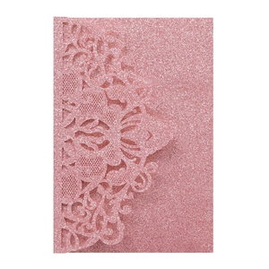 Detail of pink glitter laser-cut lace invitation cover with mandala cutout patterns
