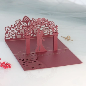Macro detail of 3D laser-cut wedding invitation featuring a burgundy heart arch and couple