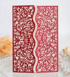 Detailed laser-cut wedding invitation cover with elegant red glitter floral patterns