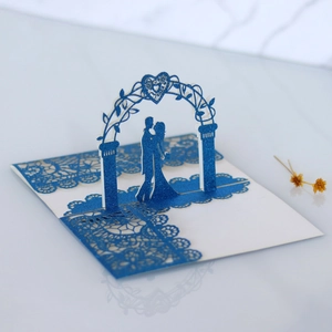 Macro detail of 3D pop-up wedding card featuring a blue glitter laser cut floral arch