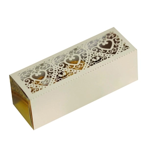 Detail of laser-cut heart patterns on ivory gift box with elegant gold lining
